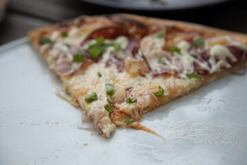 Delicious Pepperoni Pizza topped with cheese and Green onions close-up