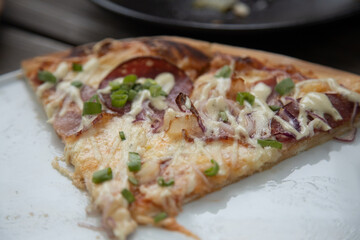 Delicious Pepperoni Pizza topped with cheese and Green onions close-up