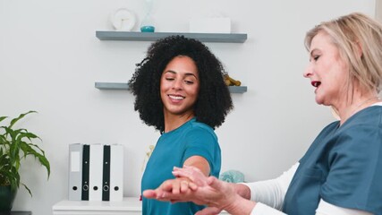 Senior Physiotherapist Provides Professional Sports Massage And Physical Therapy To A Young Black Client In A Modern Small Practice Clinic, Focusing On Health And Wellness