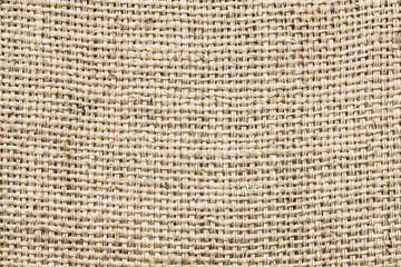 Closeup of burlap fabric texture. Natural jute sack material background. Woven coarse fiber...