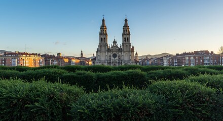 Obraz premium Stunning view: bilbao, es - feb 29, 2024: a stunning view of the cathedral of santiago in bilbao, spain, with a clear blue sky and surrounding buildings.