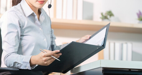 Customer Service Agent Organizing Client Documents During Call