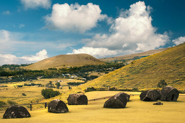 Abandoned pukao, the red topknots or hats of moai statues, on the slopes of the Puna Pau volcano, Rapa Nui (Easter Island), Chile. In this place, pukao were extracted and carved from red scoria.