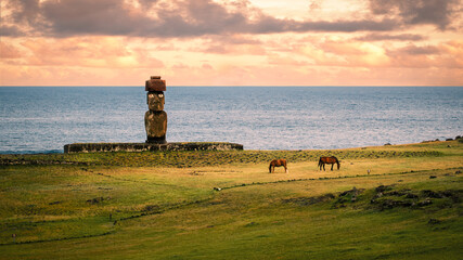 The solitary moai of Ahu Ko Te Riku, the only topknotted and eyeballed moai on the island, at the Tahai Archeological Site on Rapa Nui (Easter Island), Chile. UNESCO World Heritage Site.
