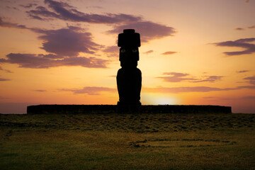 The setting sun backlights the Ahu Ko Te Riku moai, the only one with a topknot and eyes. It stands at the Tahai Archaeological Site on Rapa Nui (Easter Island), Chile, a UNESCO World Heritage Site.