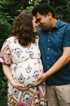 Latino husband and pregnant wife show love together