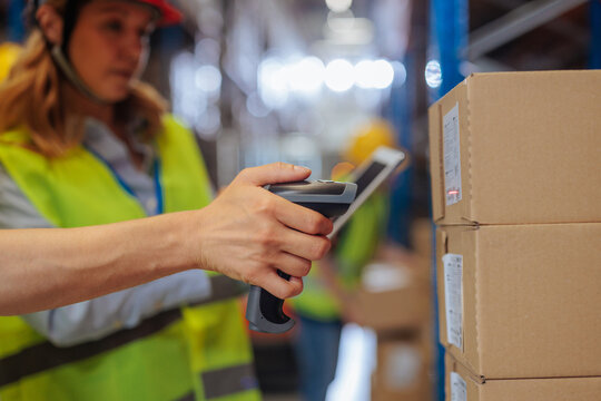 Close up of male hand using a barcode scanner on a package