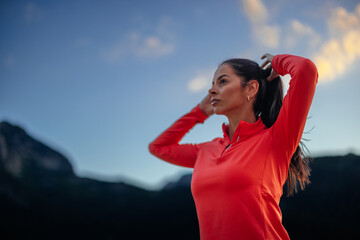 Gorgeous athletic girl fixing her pony tail
