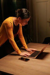 Female office worker finishing her work in the nightshift