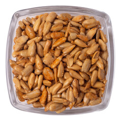 Isolated peeled sunflower seeds in teriyaki sauce in a glass pot on white background, top view