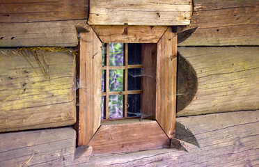 a small square window in an old wooden house of a wealthy Ukrainian peasant
