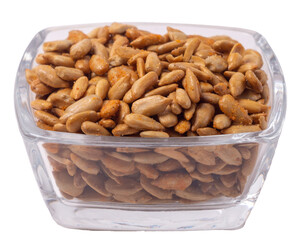 Isolated peeled sunflower seeds in teriyaki sauce in a glass pot on white background, side view