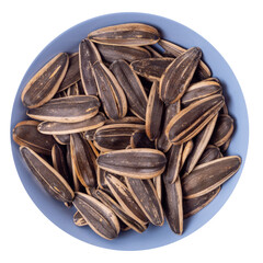 Big sunflower seeds in a shell in a round blue plate isolated on white background, top view