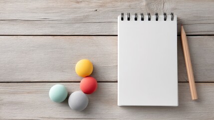Children behavior improvement concept. Blank notepad with colorful balls and a pencil on a rustic wooden surface.