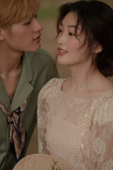 Romantic couple in soft light gazing at each other.