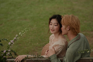 Couple embracing in a serene outdoor setting.