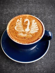 Swan Latte Art in Blue Coffee Cup on Dark Table