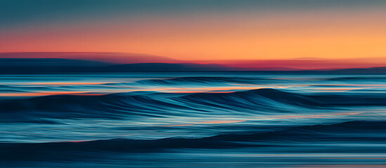 Obraz premium Abstract coastal art featuring long exposure and intentional camera movement at dusk, blending vibrant orange and deep blue ocean waves.
