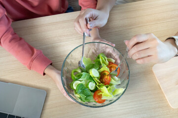 Healthy Cooking. Enjoying a fresh salad together, promoting healthy habits and family connection.
