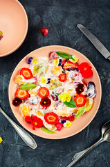 Fruit salad decorated with flowers.