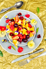 Plate of fresh fruit salad, healthy summer meal.