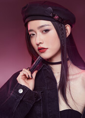 Stylish female model with makeup in sophisticated pose.