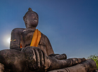 Ancient states of Buddha on the background of blue sky in Ayutthaya Thailand