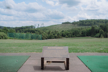 Warning Sign at Golf Driving Range with Scenic View