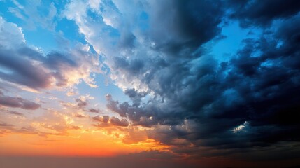Obraz premium Dramatic sky panorama with wide-angle perspective, capturing vivid clouds and contrasting warm and cool colors at sunrise and sunset