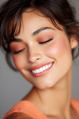 smiling model with coral blush and natural eyebrows soft beauty portrait