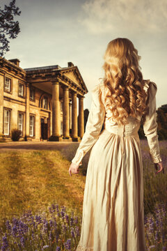 Woman In Flowing Dress Facing Building