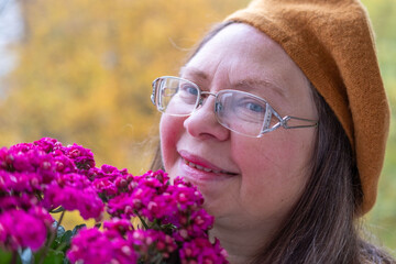 flower gift, Autumn's gentle embrace, woman's serene moment with aster blooms, essence of fall,...