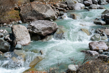Ala-Archa Park, Clear glacial Whitewater river cascades, rocky mountain valley. Boulders,...