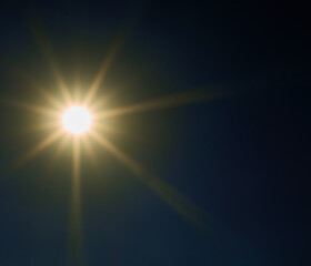 bright sun shines in the blue sky