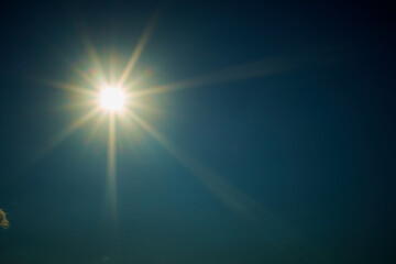 bright sun shines in the blue sky
