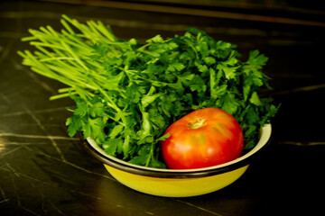 tomato and parsley are lying on a plate