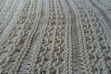 Close view of light beige handmade crochet lacy fabric