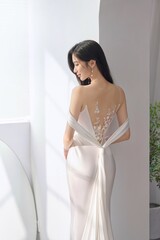 Elegant woman in a sophisticated dress with floral design.