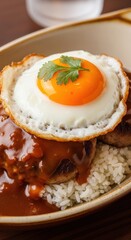 Hawaiian loco moco with a hamburger patty, fried egg, and rich brown gravy on a bed of rice
