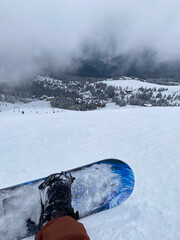 Snowboarder on Slope Overlooking Ski Resort