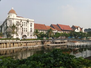 A scenic shot of historical Dutch colonial-style buildings along the Kali Besar river in Jakarta's...