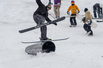 Dragobrat, Ukraine - April 8, 2023: Skier Performing Trick on Rail in Snowy Terrain Park