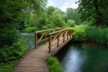 Fototapeta premium A wooden bridge spans a river amidst lush greenery with trees bordering the water and sky visible above