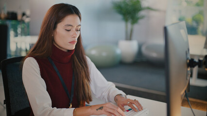 Focused woman providing tech support for customer service call center. She offers professional help...