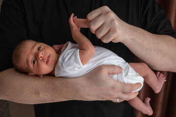Newborn Baby Cradled in Hand