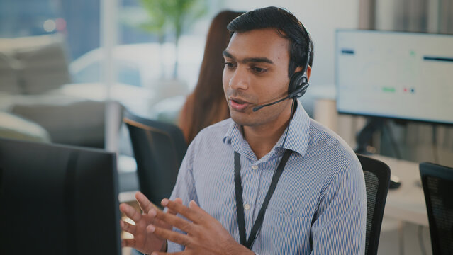 Corporate customer service team including Indian business man and black woman in headset, consulting clients, handling telemarketing, CRM solutions, phone calls and professional communication