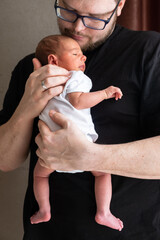 Man Holding Newborn Baby in Tender Moment