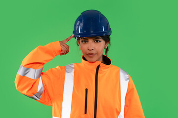 Construction worker demonstrates safety awareness in bright gear against a green background during a safety training session