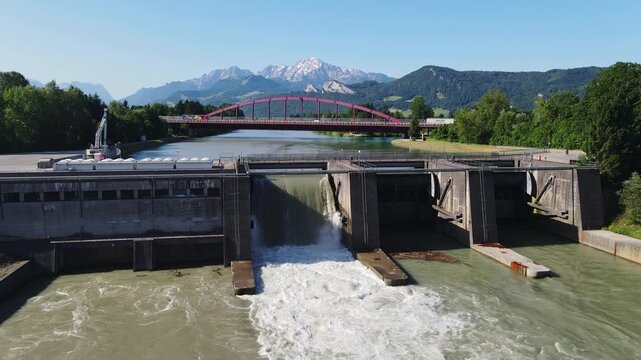 Aerial shot of cyclist riding over dam at Kraftwerk Urstein by Salzach River