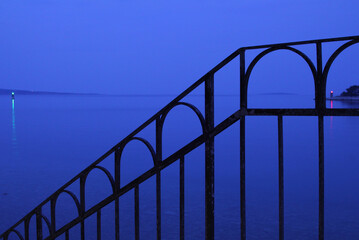 Minimalist Iron Railing Silhouette Against Twilight Blue Waterscape